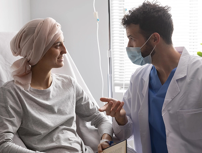Medical provider discussing palliative treatment plan with patient and caregiver