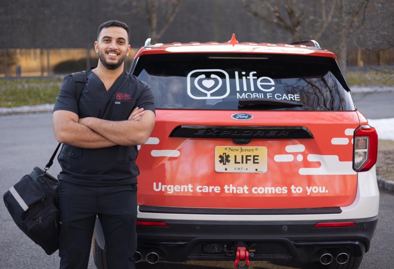 Mobile urgent care provider standing next to Life Medical car